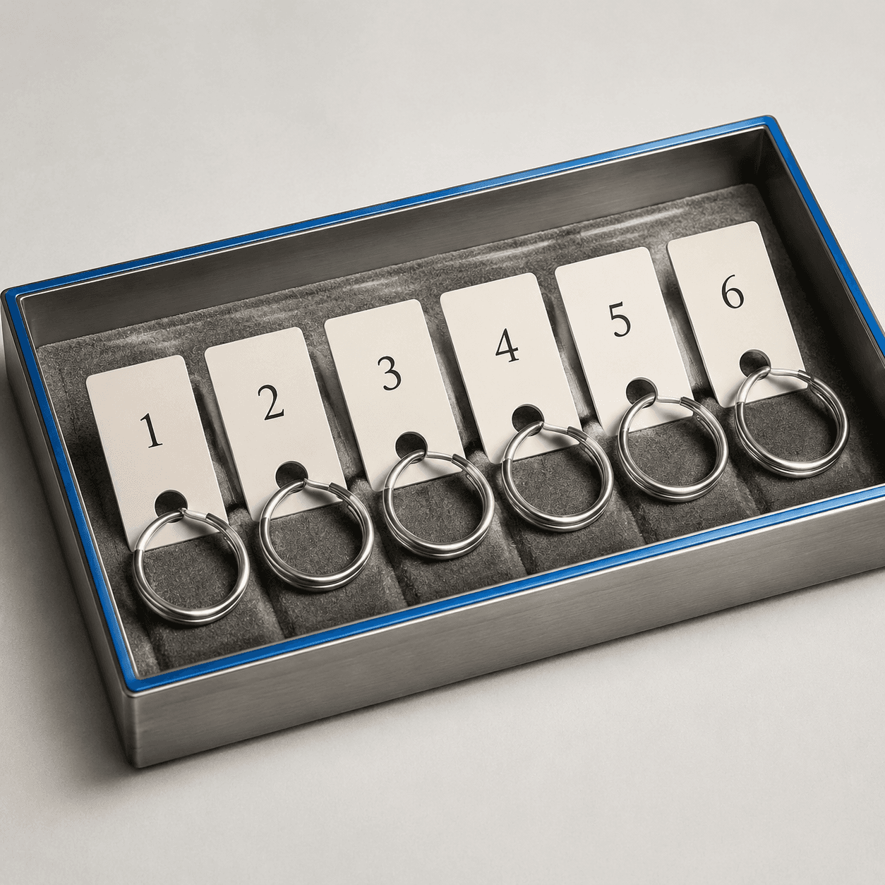 Ring Tray Look — A split-ring tray board — numbered cream tags threaded on blank rings.